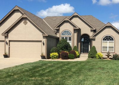 Exterior painting project image of local house with tan paint.