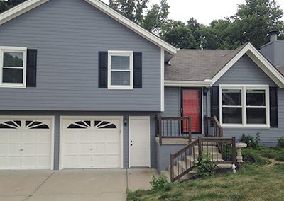 Exterior painting project image of local house with blue and white paint.