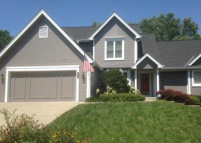 Exterior painting project image of local house with grey and white paint.