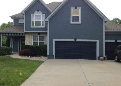 Exterior painting project image of local house with blue and white paint.