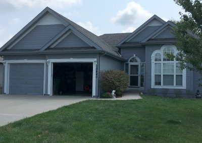 Exterior painting project image of local house with grey and white paint.